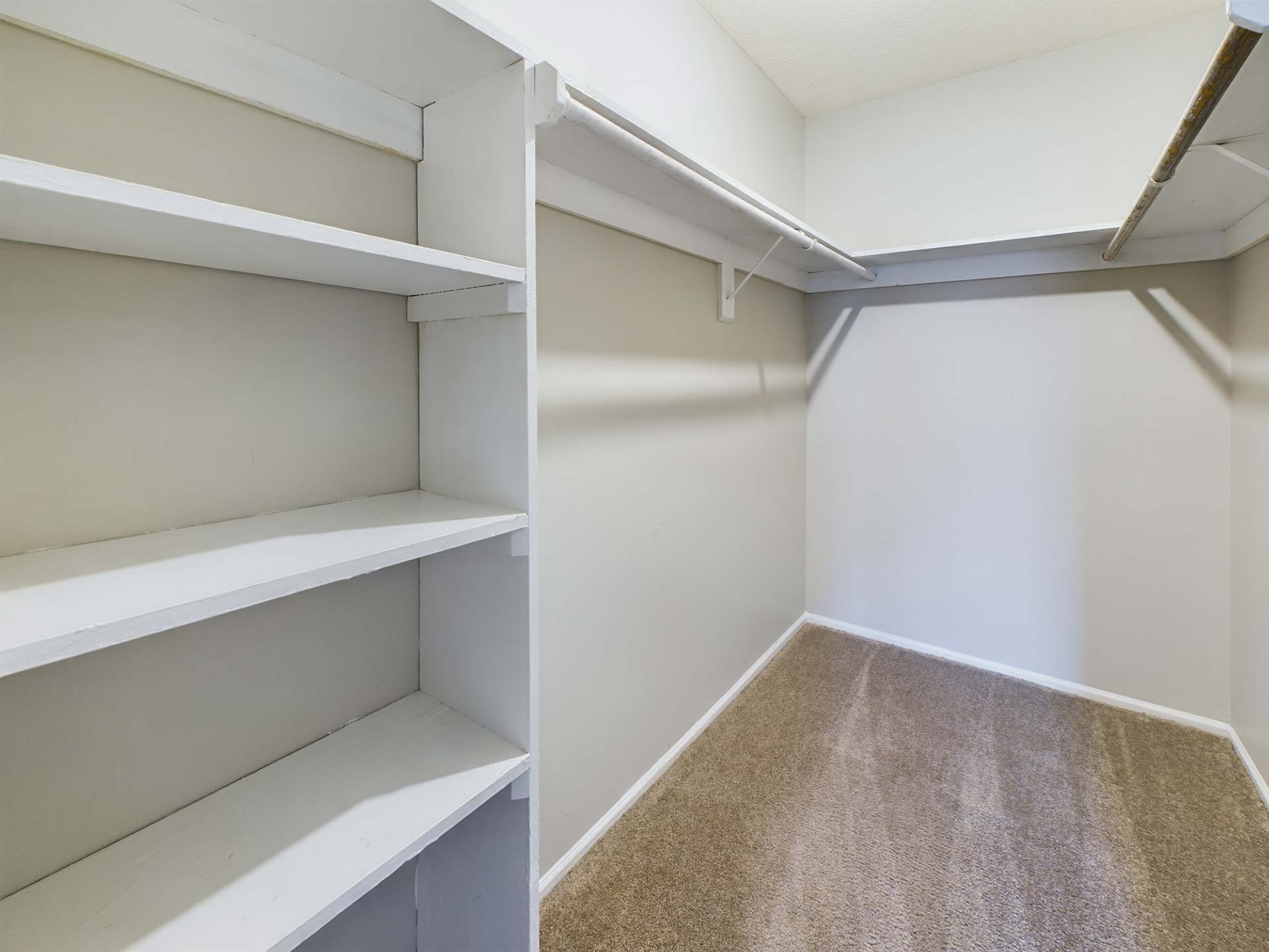 a closet with shelves and a door with a shelf at The Edgewater