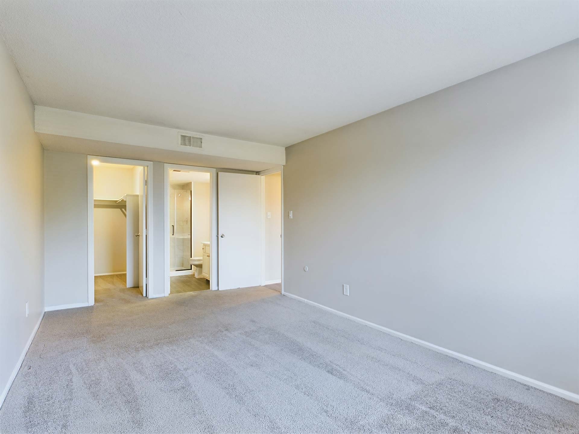 empty room with carpet and white walls at The Edgewater