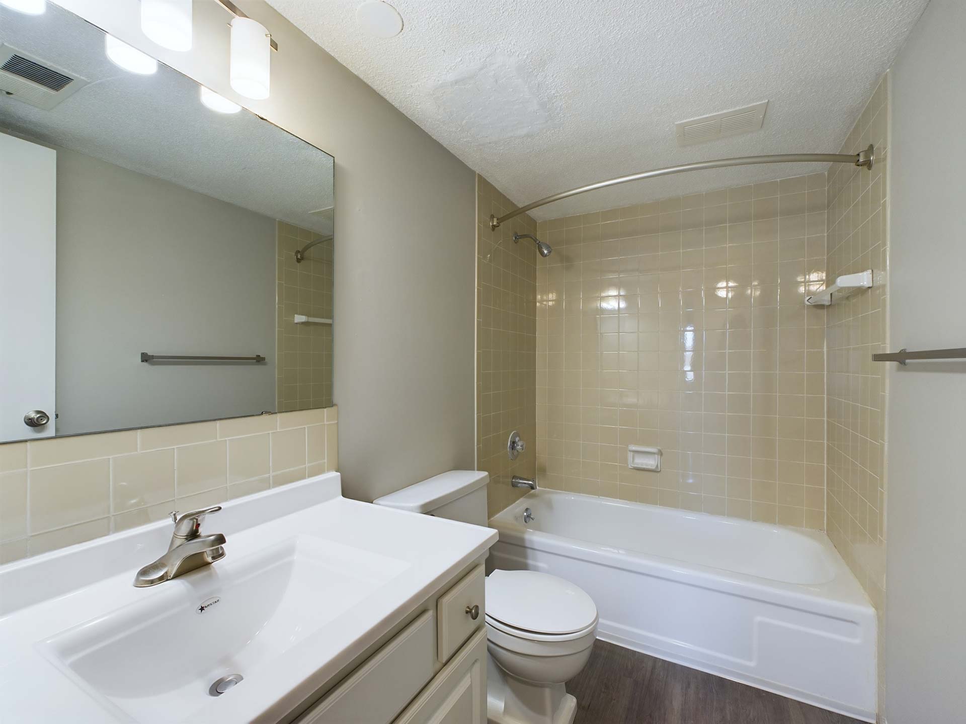 a bathroom with a tub, sink and toilet at The Edgewater
