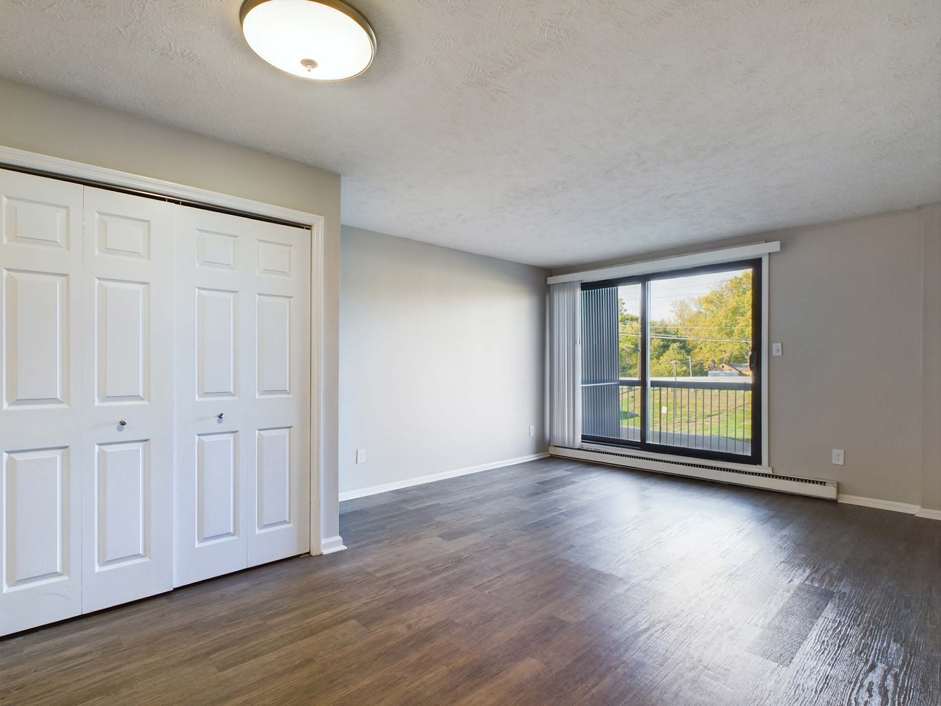 empty room with hardwood floors and sliding glass doors at The Edgewater