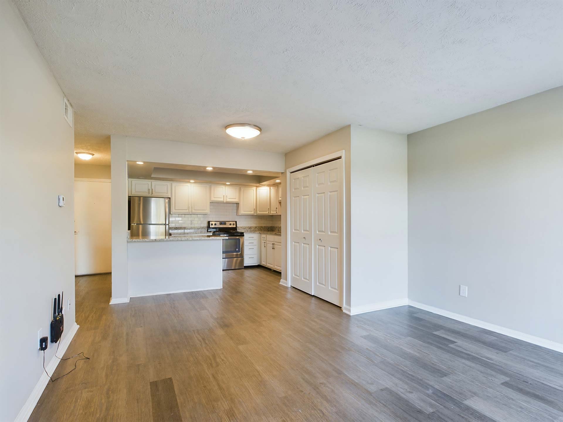 empty room with hardwood floors and white walls at The Edgewater