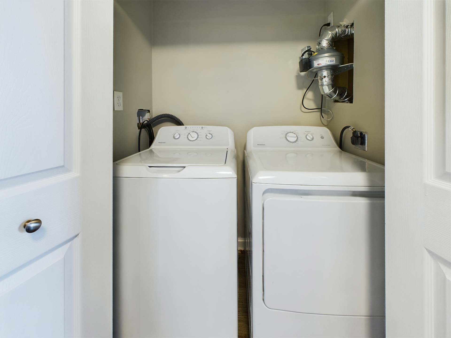 a washer and dryer in a small laundry room at The Edgewater