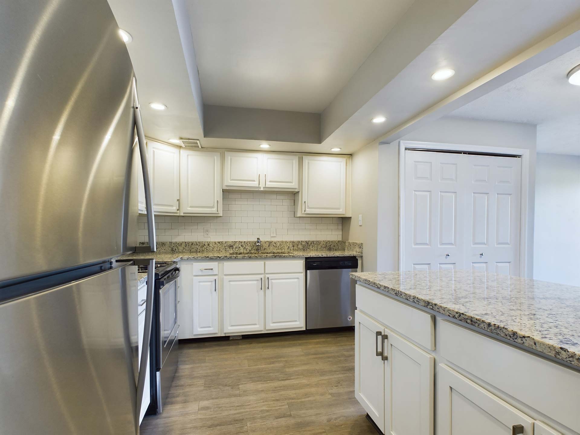 a kitchen with stainless steel appliances and granite counter tops at The Edgewater