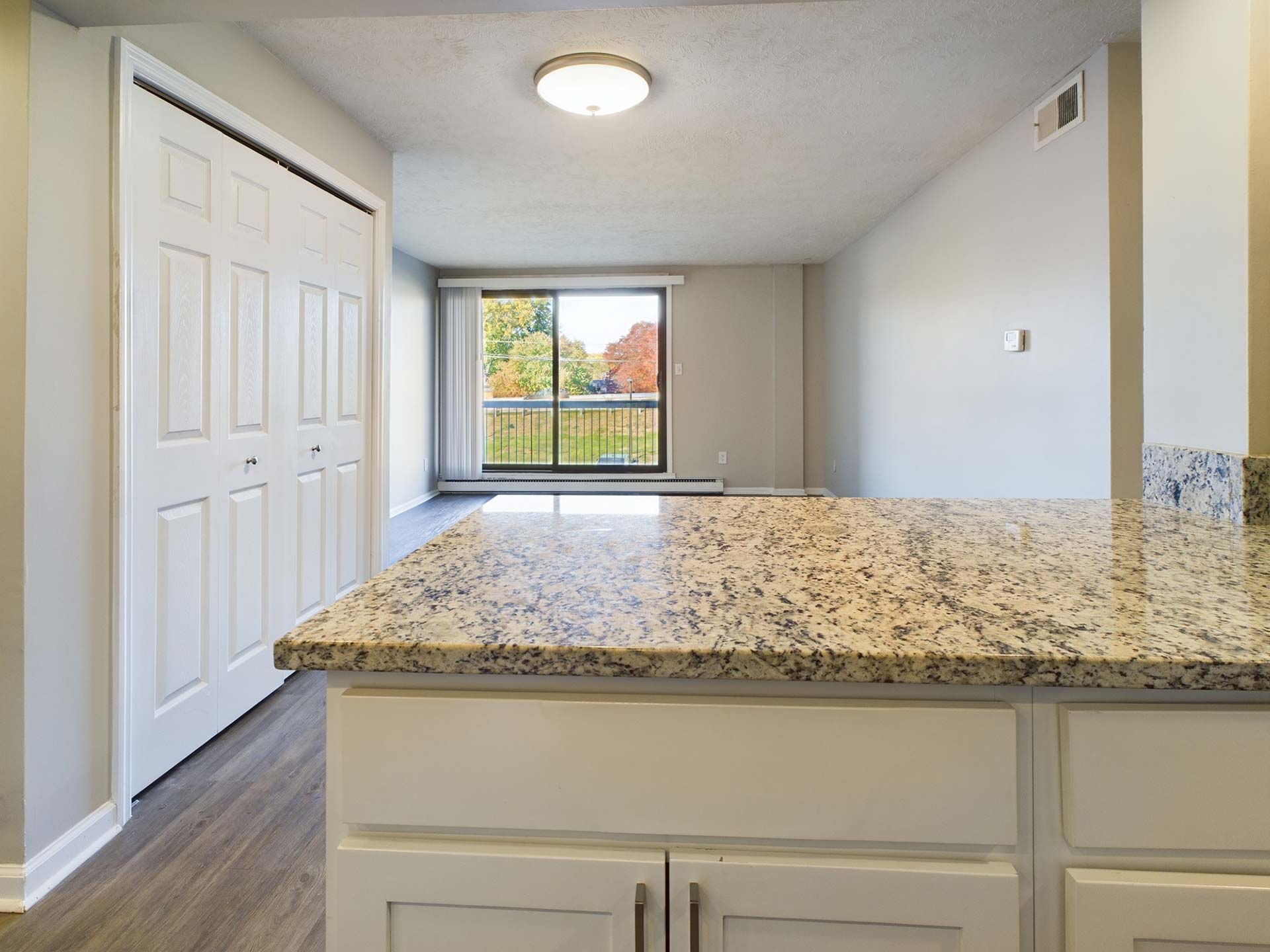 a kitchen with granite counter tops and a large window at The Edgewater