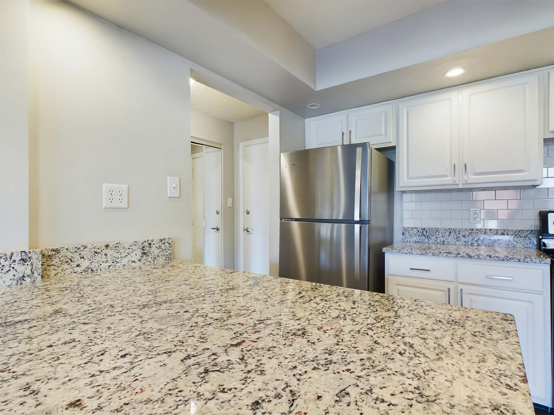 a kitchen with granite counter tops and stainless steel appliances at The Edgewater